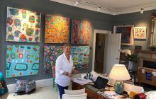 Julia Krone in her gallery - with art work from her Colour exhibition 