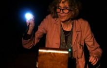Maria MacDonell is pictured with a light, looking over the sewing box that contains Miss Lindsay's letters.
