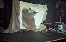 Screen made from a sheet; actor washes behind the screen while still talking.