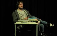 Jnusz sits in chaos at his desk, wondering how to remove the clutter and focus on his studies.