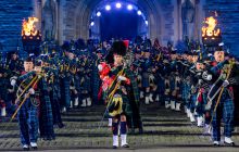 Regimental pipes and drums march through Edinburgh castle gate