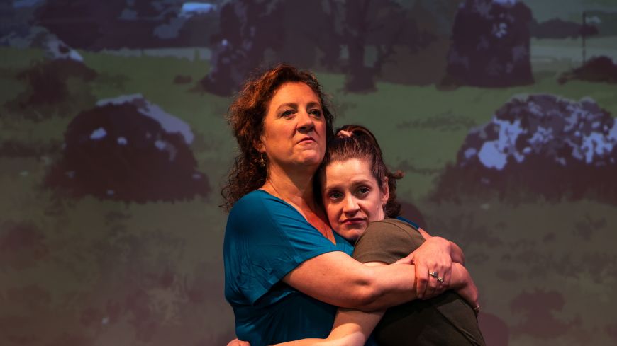 Two of the actors hug on stage - Annie Lareau, Brenda Joyner
